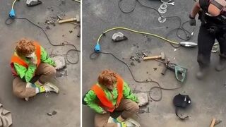 Activist glued to the road, requires powertools to break free