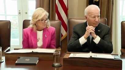 Biden sits quietly as reporters ask questions. He looks confused
