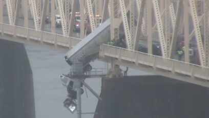 Semi Truck hangs off bridge, first responders rush into action