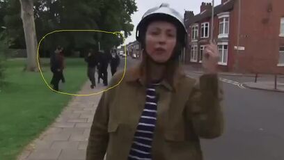 Listen to the reporter, then look in the background