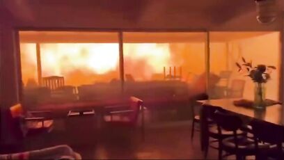 Two men and dog in home surrounded by Palisades fire