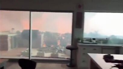 Two men and dog in home surrounded by Palisades fire