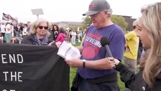 Protester doesn't know what he's doing, needs to read paper to remember