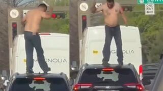 Man jumps on stranger's car in traffic