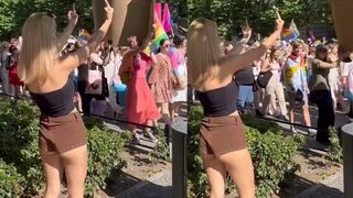 Woman shows one-handed gesture to protesters