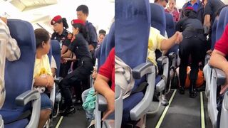 Large 'Man Child' in Garfield shirt dragged off a plane