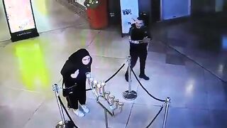 Muslim woman blows out menorah candles during Hannukah