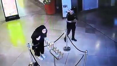 Muslim woman blows out menorah candles during Hannukah