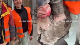Two protesters have hands stuck in concrete