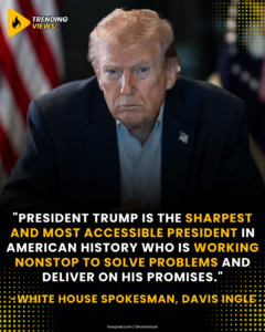 President Donald Trump seated with a serious expression, flanked by American flags